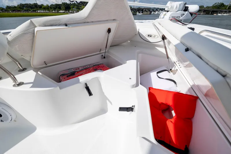 Slide: The Image of 2016 Sea Hunt Ultra 225 boat interior with storage compartments and life jackets. - 10