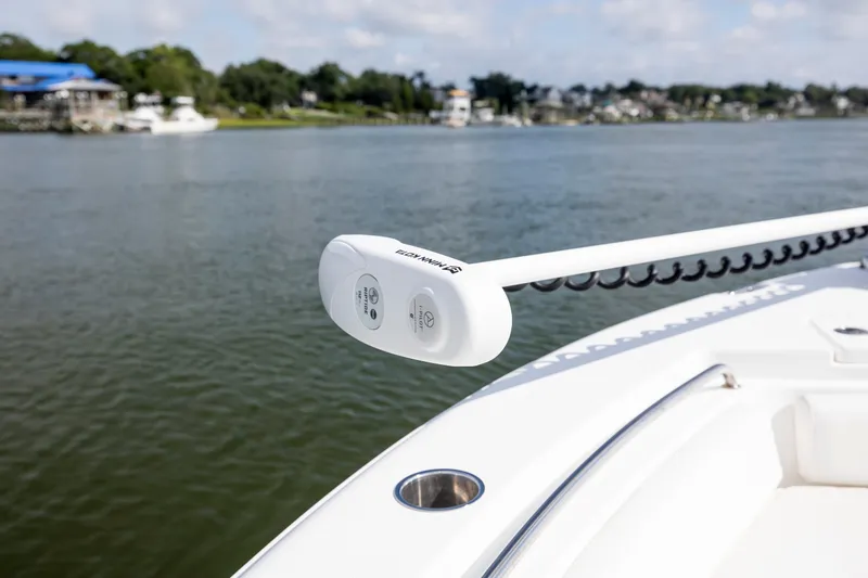 Slide: The Image of 2016 Sea Hunt Ultra 225 boat with trolling motor on calm water. - 11