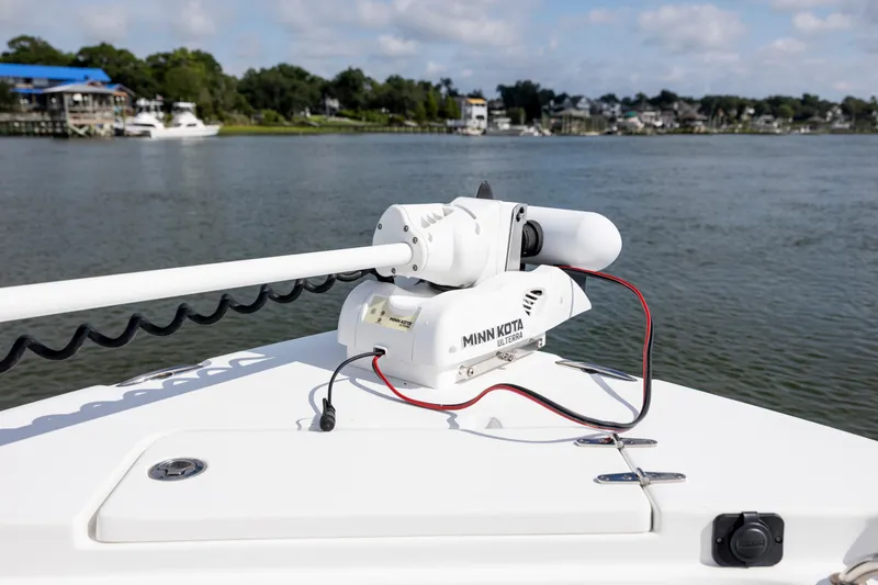 Slide: The Image of 2016 Sea Hunt Ultra 225 with Minn Kota trolling motor on calm water. - 12