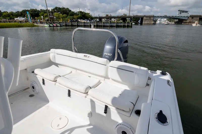 Slide: The Image of 2016 Sea Hunt Ultra 225 boat with Yamaha 200 engine, docked near a bridge. - 18