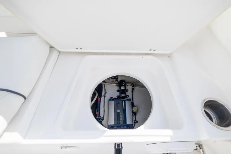 Slide: The Image of 2016 Sea Hunt Ultra 225 boat storage compartment with visible electrical components. - 21