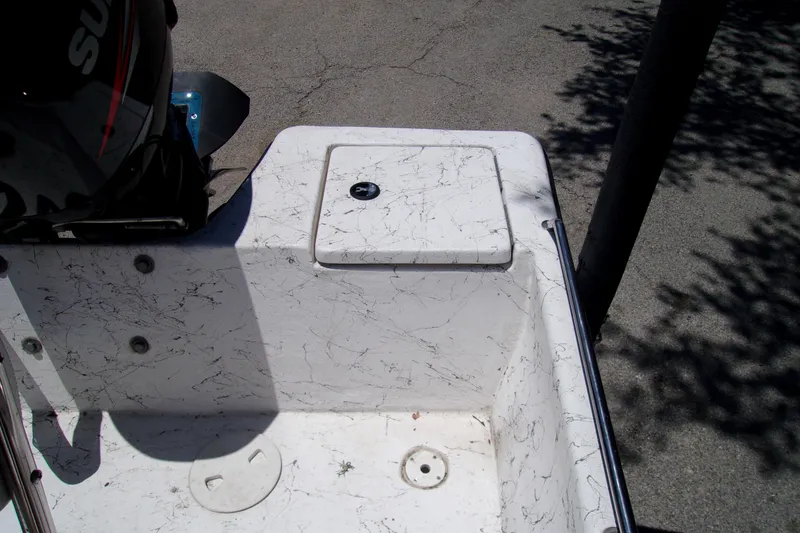 Slide: The Image of 2011 Blue Wave 180 Super Tunnel boat interior with motor and storage compartment. - 6