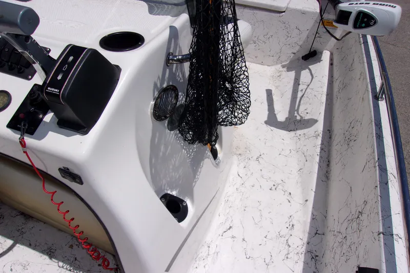 Slide: The Image of 2011 Blue Wave 180 Super Tunnel boat interior with control panel and fishing net. - 8