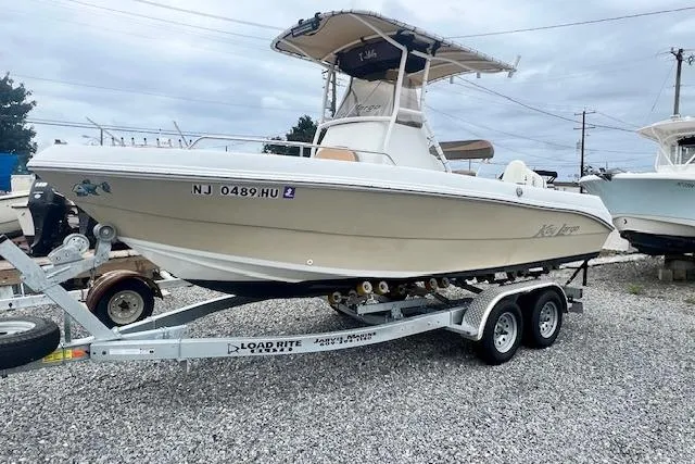 The Image of 2019 Key Largo 2100 WI boat on trailer, parked on gravel lot. - 0
