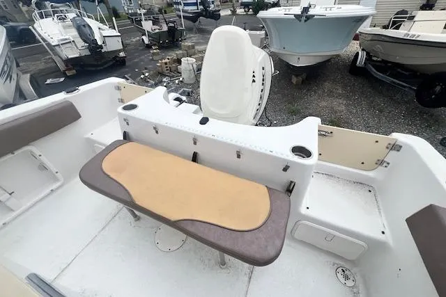 Slide: The Image of 2019 Key Largo 2100 WI boat interior with seating and storage compartments. - 6