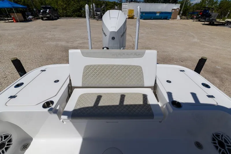 Slide: The Image of 2022 Caymas 26 HB boat with cushioned seating and storage compartments. - 10