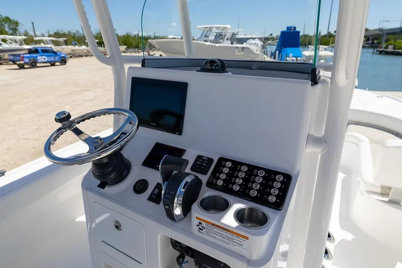 Slide: The Image of 2022 Caymas 26 HB boat console with steering wheel and control panel. - 11