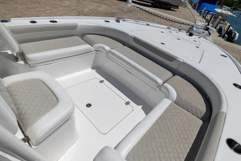 Slide: The Image of 2022 Caymas 26 HB boat interior with cushioned seating and storage compartments. - 14
