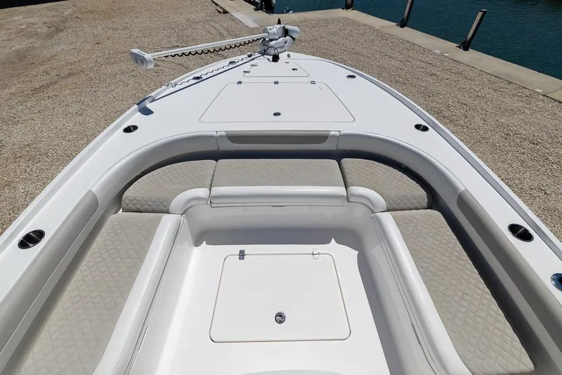 Slide: The Image of 2022 Caymas 26 HB boat bow with cushioned seating and storage compartment. - 15