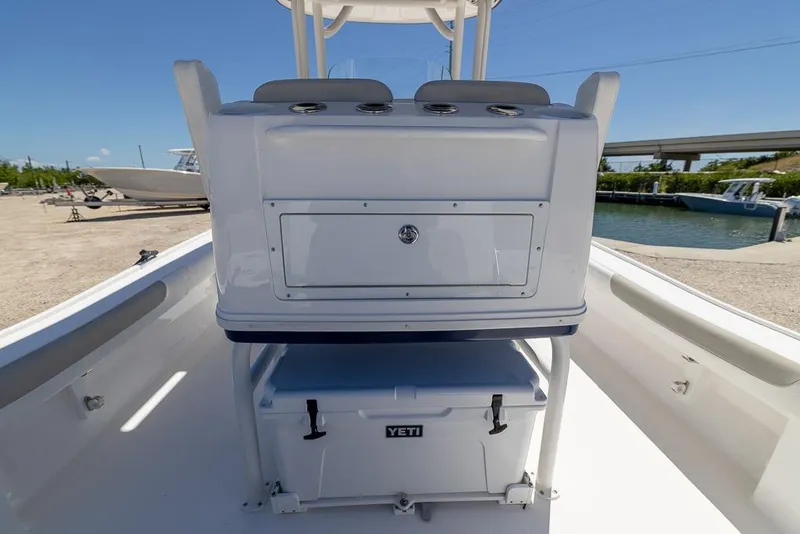 Slide: The Image of 2022 Caymas 26 HB boat interior with Yeti cooler and storage compartment. - 17