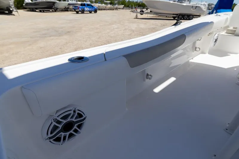 Slide: The Image of 2022 Caymas 26 HB boat interior with speaker and rod holder. - 19