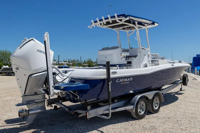 Slide: The Image of 2022 Caymas 26 HB boat on trailer, featuring a powerful outboard motor. - 3