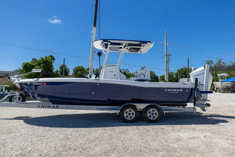 Slide: The Image of 2022 Caymas 26 HB boat on trailer under clear blue sky. - 6