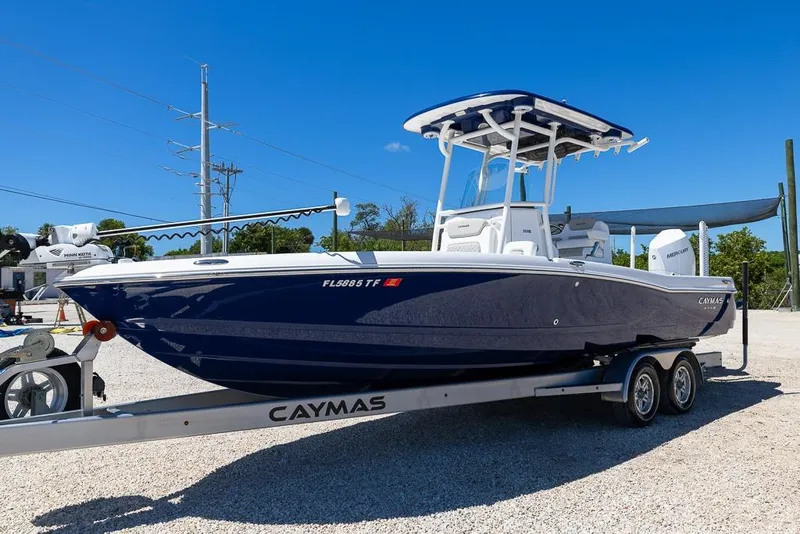Slide: The Image of 2022 Caymas 26 HB boat on trailer, blue hull, sunny day, outdoor display. - 7