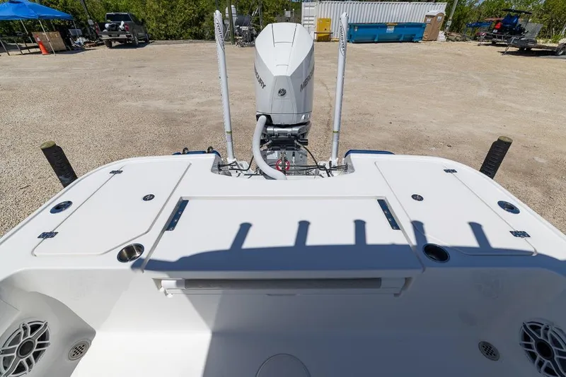 Slide: The Image of 2022 Caymas 26 HB boat with Mercury engine, parked on gravel lot. - 8