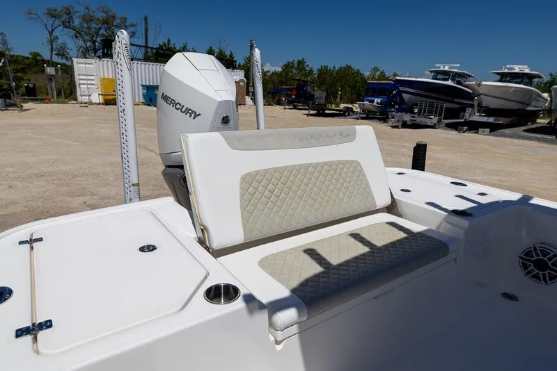 Slide: The Image of 2022 Caymas 26 HB boat with Mercury engine, featuring cushioned seating and storage compartments. - 9