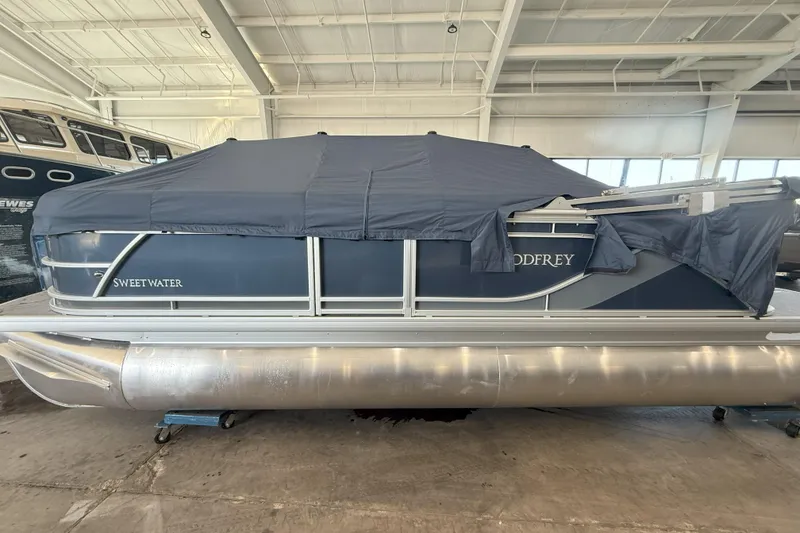 Slide: The Image of 2026 Godfrey Sweetwater 2086 C pontoon boat covered in a storage facility. - 1