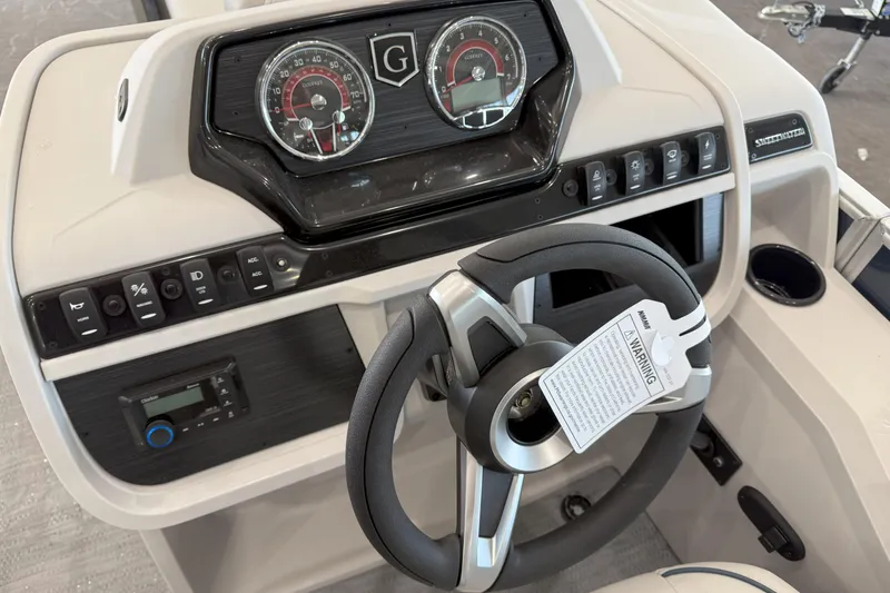 Slide: The Image of 2026 Godfrey Sweetwater 2086 C dashboard with steering wheel and control panel. - 10