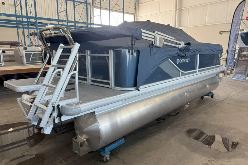 Slide: The Image of 2026 Godfrey Sweetwater 2086 C pontoon boat in showroom, covered and on display. - 4