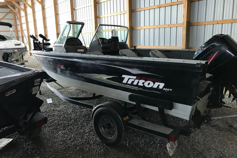 The Image of 2009 Triton DV 17 Liberty boat on trailer in storage shed. - 0