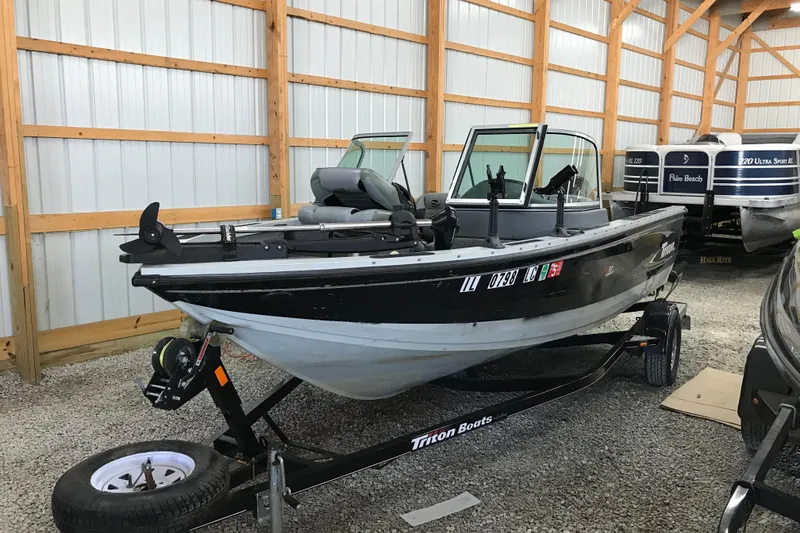 Slide: The Image of 2009 Triton DV 17 Liberty boat on trailer in storage facility. - 12