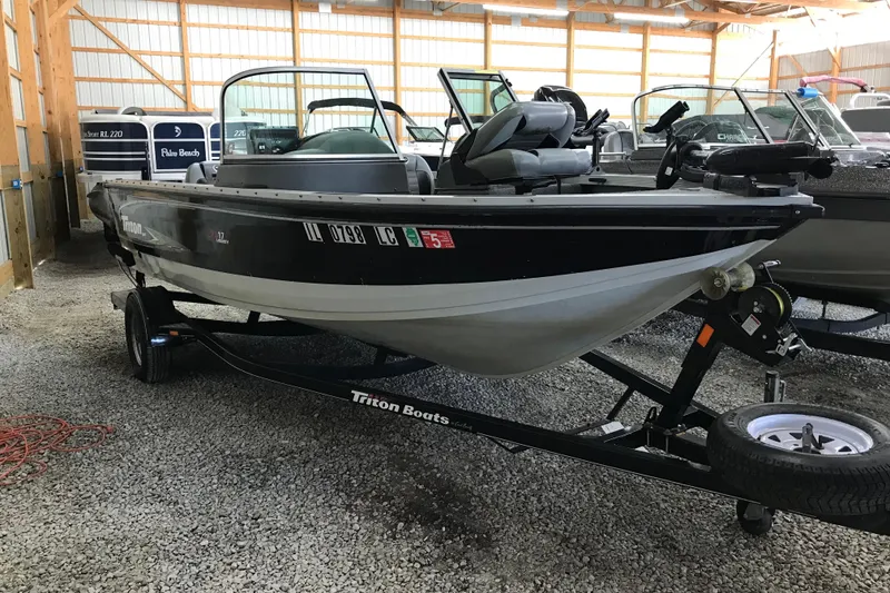 Slide: The Image of 2009 Triton DV 17 Liberty boat on trailer in storage facility. - 13
