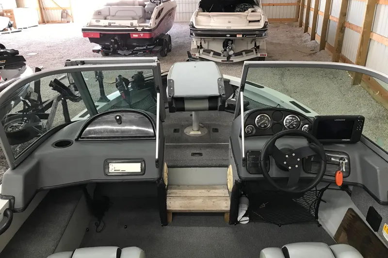 Slide: The Image of 2009 Triton DV 17 Liberty boat interior with steering wheel and dashboard in storage. - 14