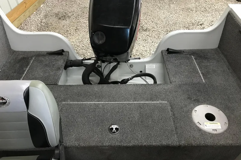 Slide: The Image of 2009 Triton DV 17 Liberty boat interior with motor and seating. - 15