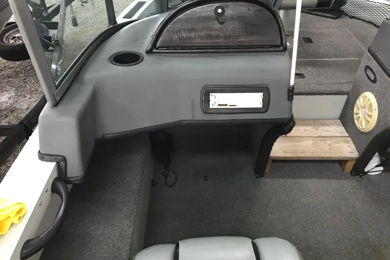 Slide: The Image of 2009 Triton DV 17 Liberty boat interior with gray seating and dashboard. - 16