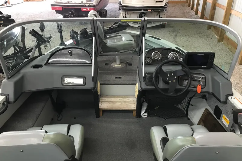 Slide: The Image of 2009 Triton DV 17 Liberty boat interior with steering wheel and dashboard controls. - 20