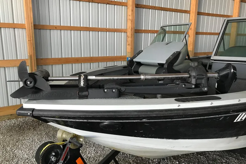 Slide: The Image of 2009 Triton DV 17 Liberty boat with trolling motor in a storage shed. - 3