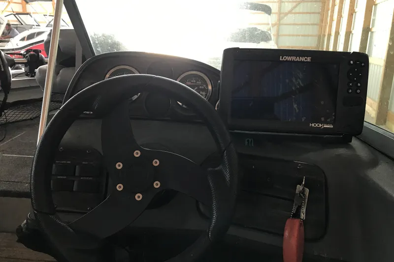 Slide: The Image of 2009 Triton DV 17 Liberty boat dashboard with steering wheel and Lowrance fishfinder. - 6