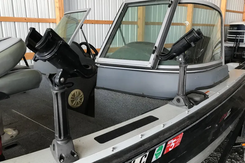 Slide: The Image of 2009 Triton DV 17 Liberty boat with rod holders in a storage area. - 9