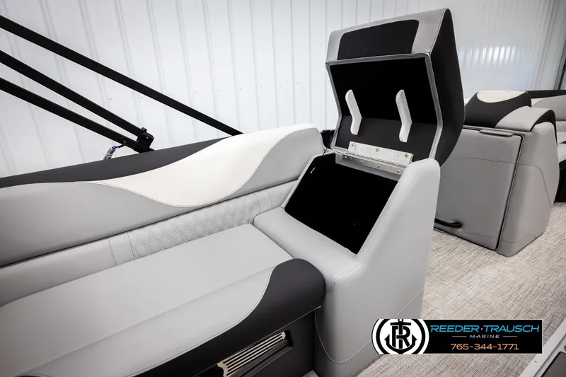 Slide: The Image of 2026 Avalon LSZ VRB boat interior with open storage compartment, featuring sleek gray and black seating. - 24