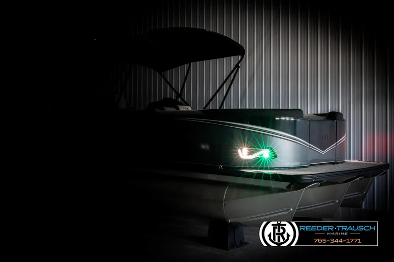 Slide: The Image of 2026 Avalon LSZ VRB pontoon boat with illuminated lights in a dimly lit setting. - 4