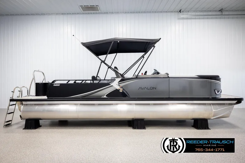 Slide: The Image of 2026 Avalon LSZ VRB pontoon boat in showroom, side view with canopy. - 5