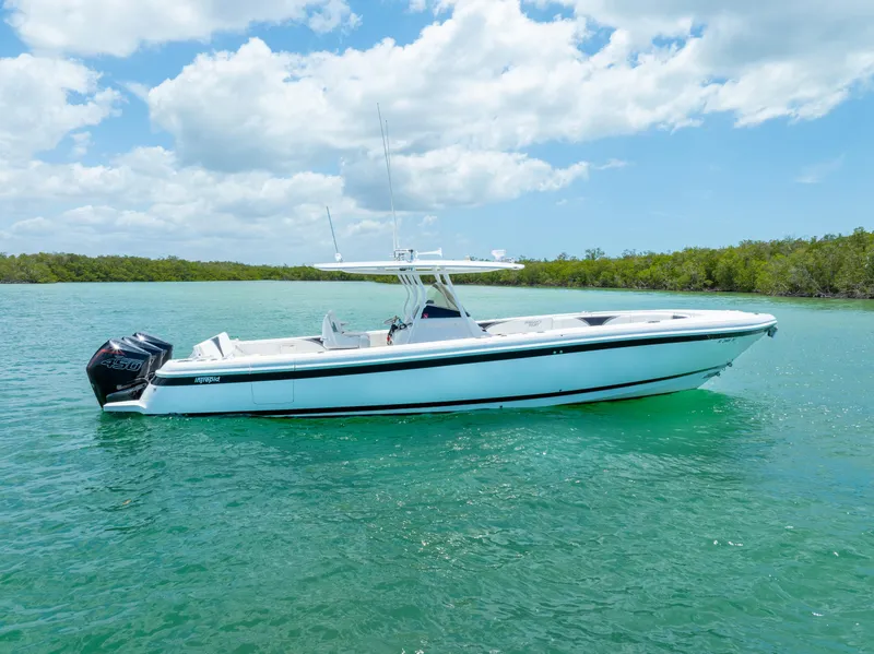 Slide: The Image of 2018 Intrepid 375 Open boat on clear turquoise water under a partly cloudy sky. - 1