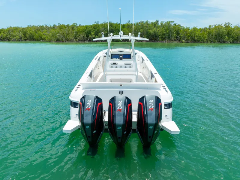 Slide: The Image of 2018 Intrepid 375 Open boat with triple outboard engines on turquoise water. - 17