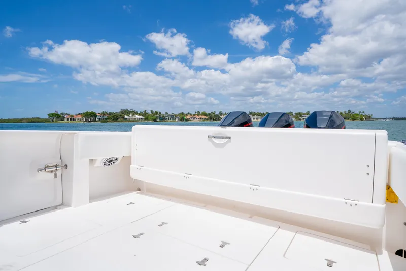 Slide: The Image of 2018 Intrepid 375 Open boat deck with outboard motors, under a clear blue sky. - 19