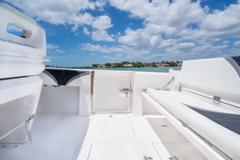 Slide: The Image of 2018 Intrepid 375 Open boat interior with white seating, under a blue sky. - 20