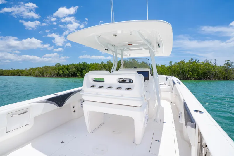 Slide: The Image of 2018 Intrepid 375 Open boat on clear water, sunny day, lush greenery background. - 21