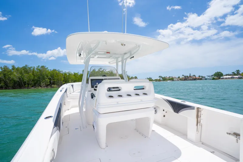 Slide: The Image of 2018 Intrepid 375 Open boat on clear water, sunny day, lush greenery in background. - 23