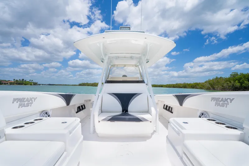 Slide: The Image of 2018 Intrepid 375 Open boat on water, clear sky, spacious seating, sleek design. - 26