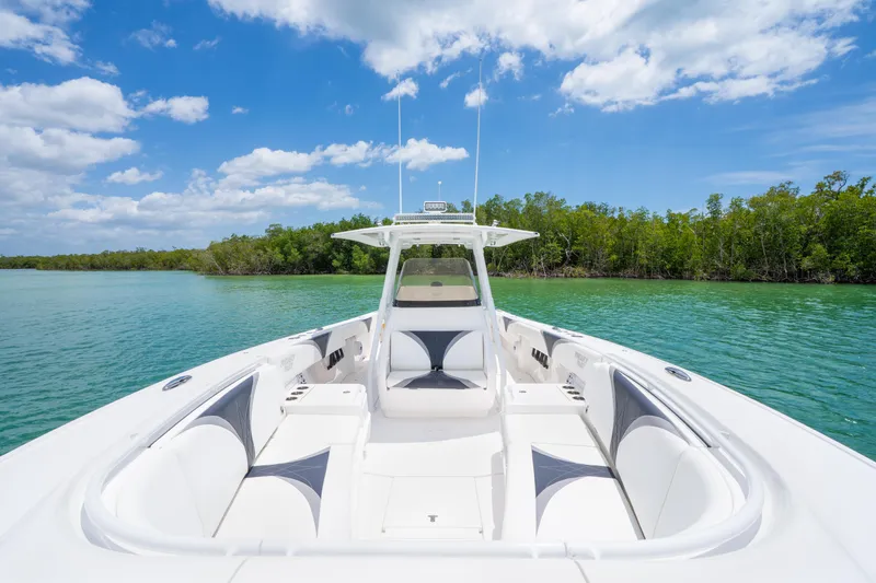 Slide: The Image of 2018 Intrepid 375 Open boat on clear water with lush green shoreline. - 27