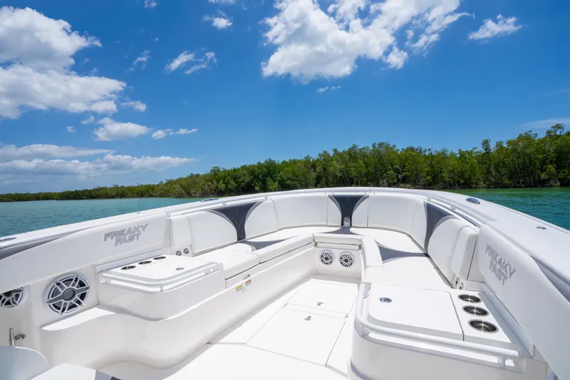 Slide: The Image of 2018 Intrepid 375 Open boat interior with seating, under a clear blue sky. - 4
