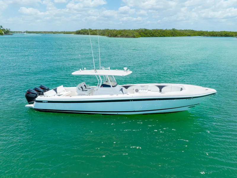 Slide: The Image of 2018 Intrepid 375 Open boat on clear turquoise water under a partly cloudy sky. - 6