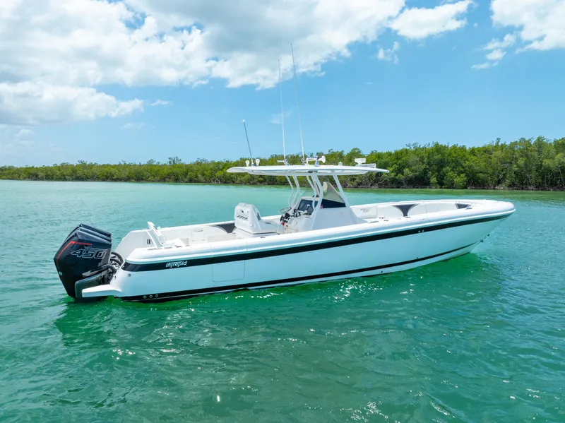 Slide: The Image of 2018 Intrepid 375 Open boat on turquoise water under a partly cloudy sky. - 7