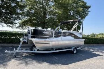 Slide: The Image of 2020 SunCatcher V20 Fish & Cruise pontoon boat on trailer, parked outdoors. - 1