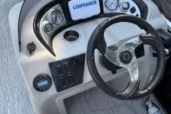 Slide: The Image of 2020 SunCatcher V20 Fish & Cruise boat dashboard with steering wheel and gauges. - 3