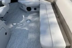 Slide: The Image of 2020 SunCatcher V20 Fish & Cruise boat interior with cushioned seating and carpeted floor. - 5